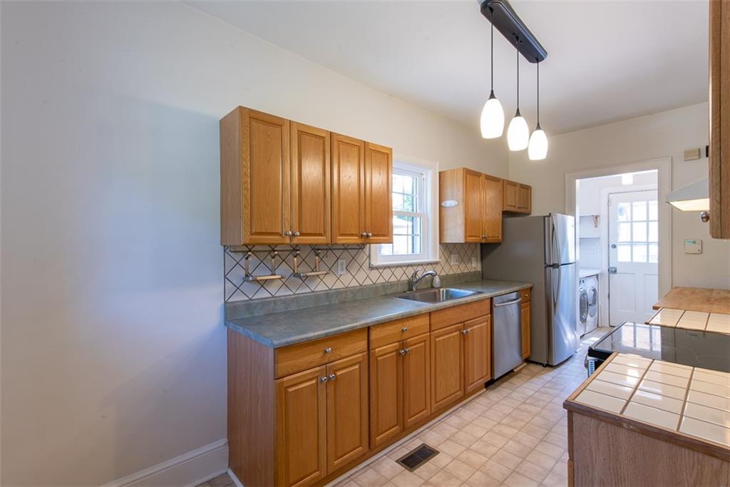 208 Shadowmoor Drive, Unit 208 Decatur, GA 30030 - Photo 7 of 29 a kitchen with stainless steel appliances a sink stove and cabinets