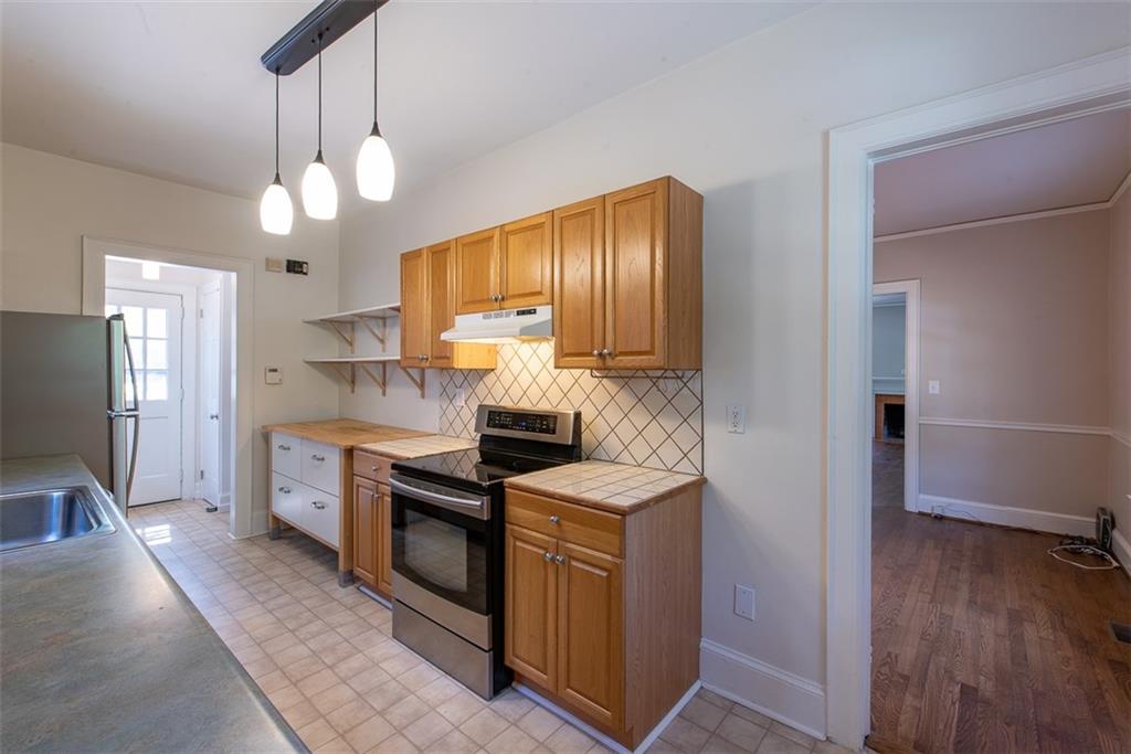 208 Shadowmoor Drive, Unit 208 Decatur, GA 30030 - Photo 8 of 29 a kitchen with stainless steel appliances granite countertop a sink a stove and refrigerator