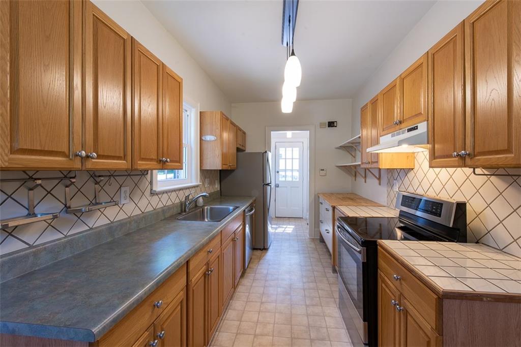 208 Shadowmoor Drive, Unit 208 Decatur, GA 30030 - Photo 9 of 29 a kitchen with stainless steel appliances granite countertop a sink stove and refrigerator