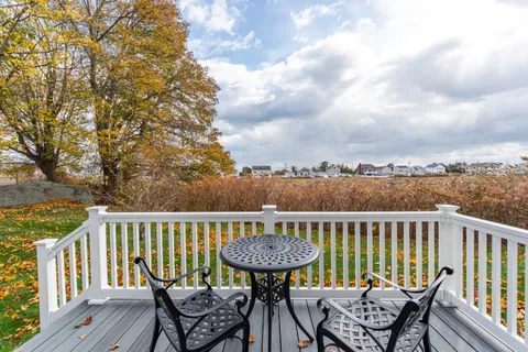 a view of a chairs and table on the deck
