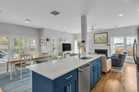 a living room with furniture and kitchen view