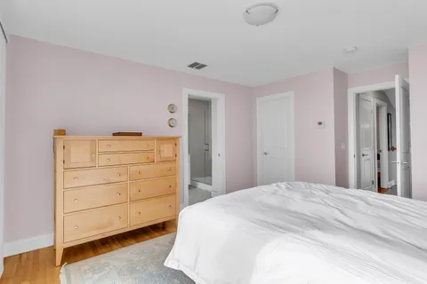 a view of a balcony with wooden floor and fence