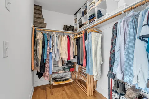 a bedroom with a dresser and a mirror