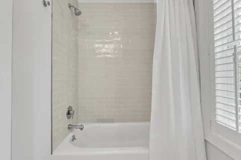 a bathroom with a sink a toilet and a window