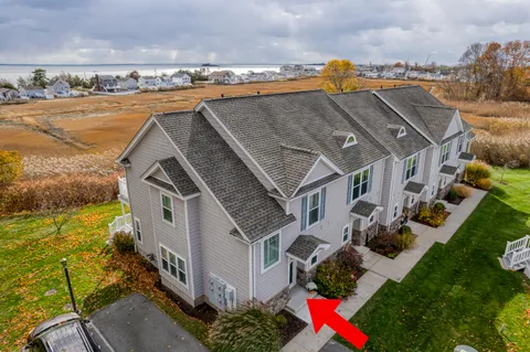 an aerial view of multiple houses with yard