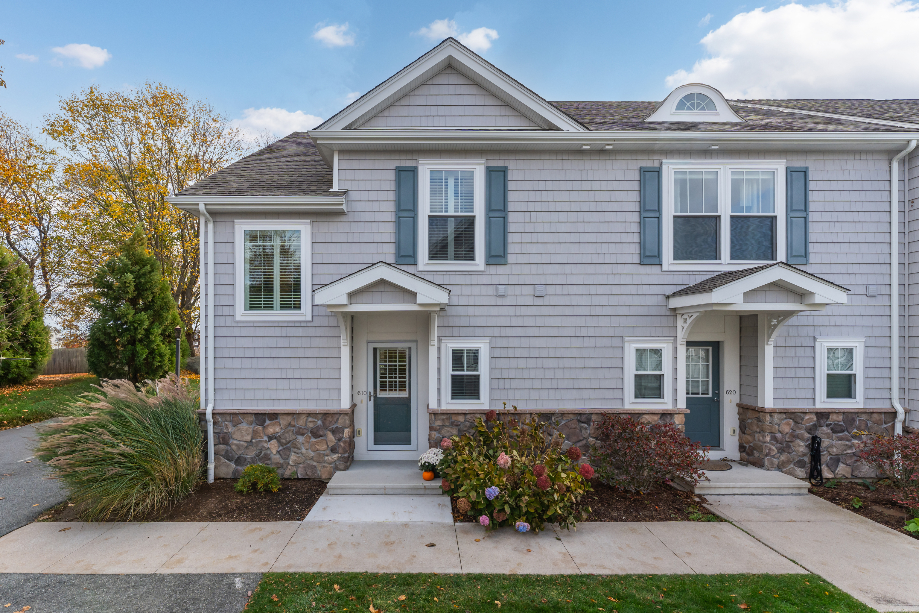 610 Marina Way Landing, Unit 610 Westbrook, CT 06498 - Photo 9 of 40 a front view of a house with a yard and potted plants