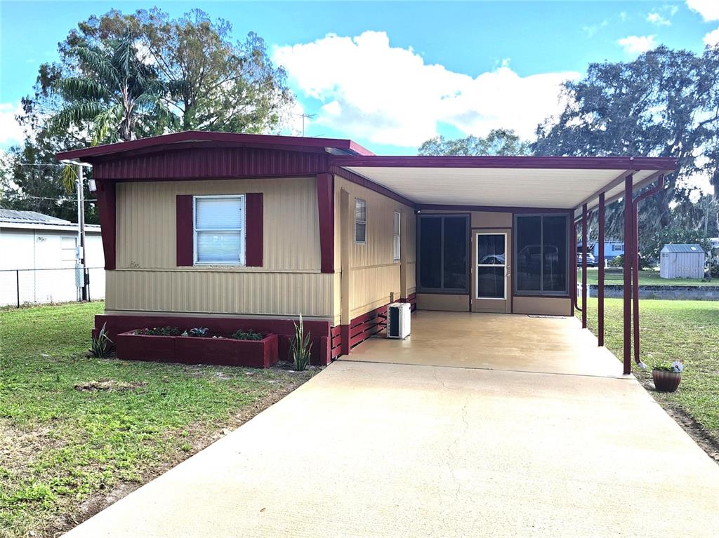 10129 East Bass Circle Inverness, FL 34450 - Photo 1 of 34 a front view of a house with a garden