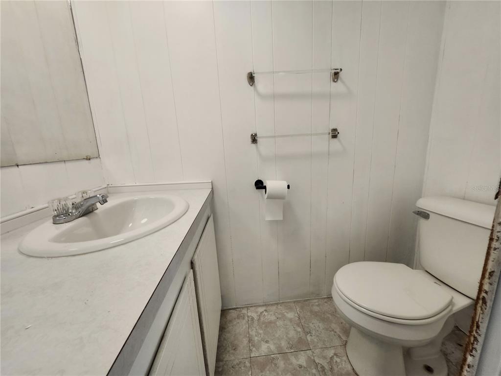 10129 East Bass Circle Inverness, FL 34450 - Photo 12 of 34 a bathroom with a sink a toilet and shower