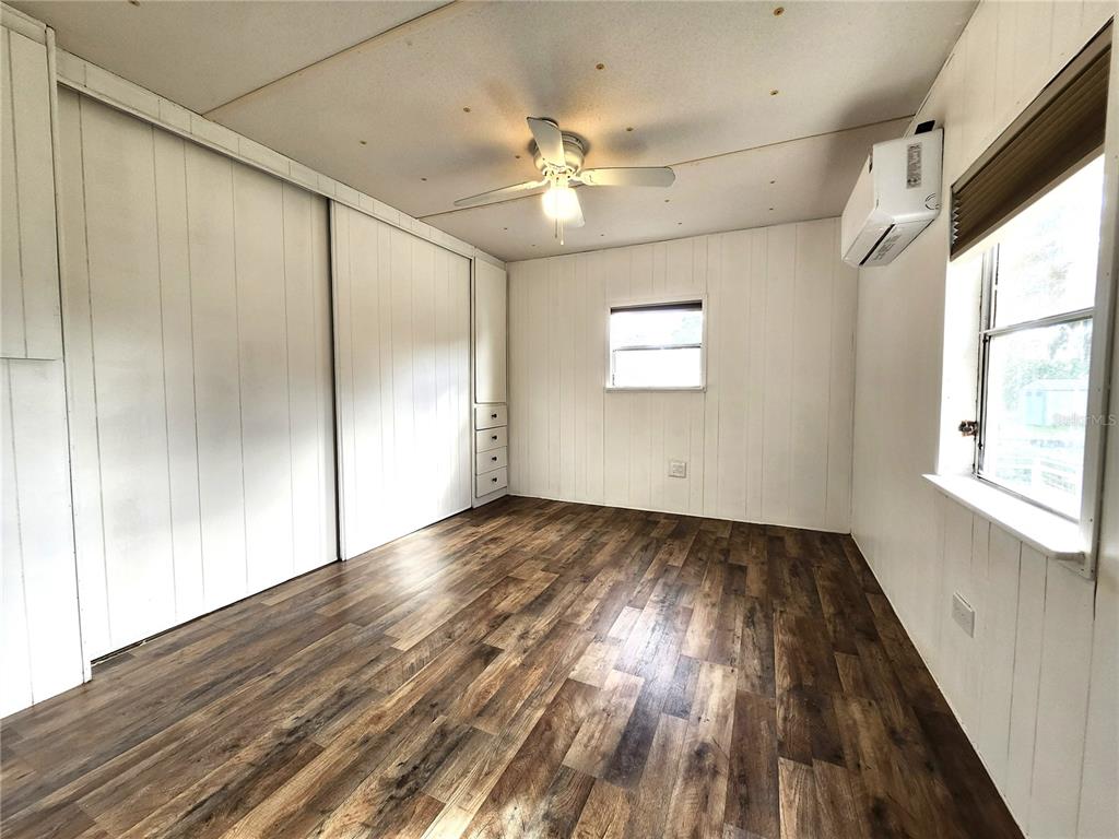 10129 East Bass Circle Inverness, FL 34450 - Photo 13 of 34 a view of an empty room with wooden floor and a window