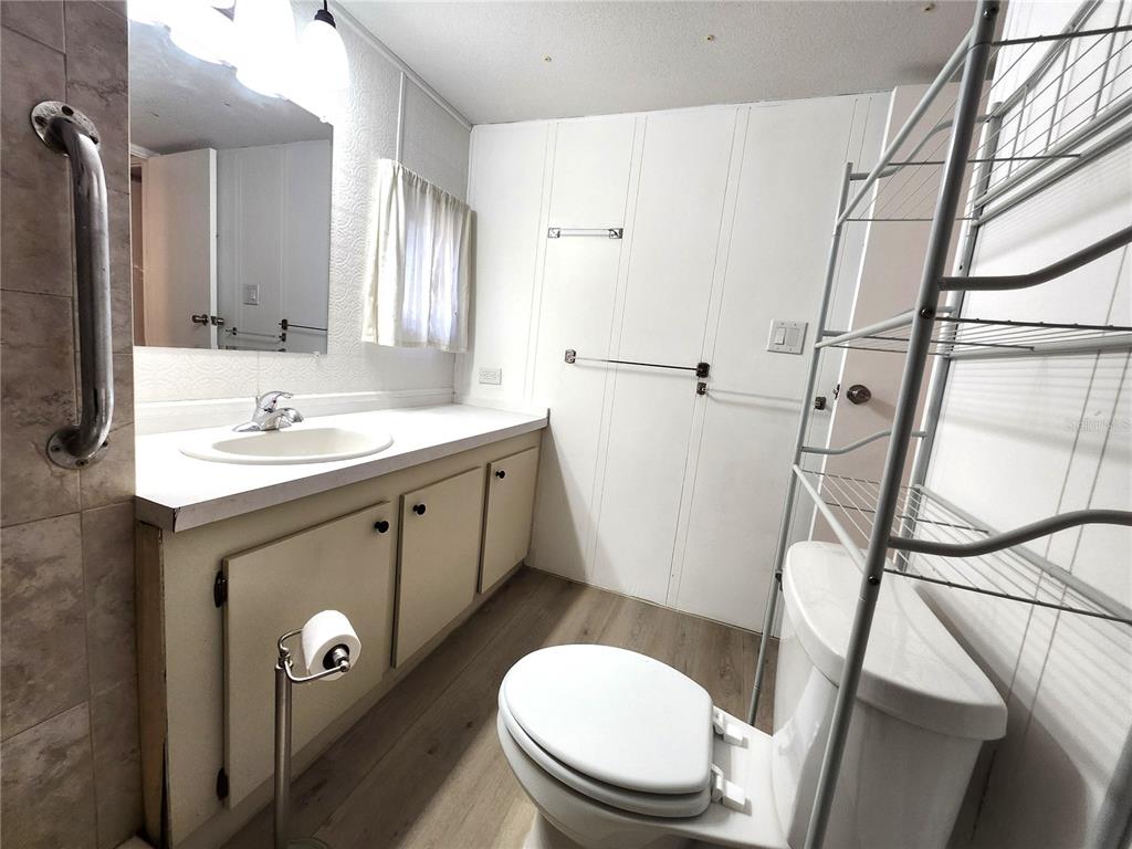 10129 East Bass Circle Inverness, FL 34450 - Photo 15 of 34 a bathroom with a toilet sink and mirror