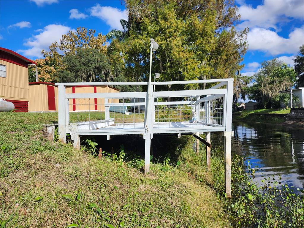 10129 East Bass Circle Inverness, FL 34450 - Photo 20 of 34 a backyard of a house with yard and outdoor seating
