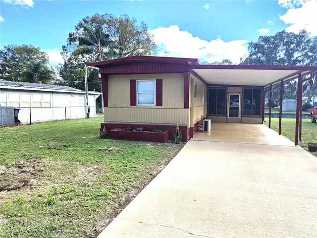 a view of a house with backyard and porch