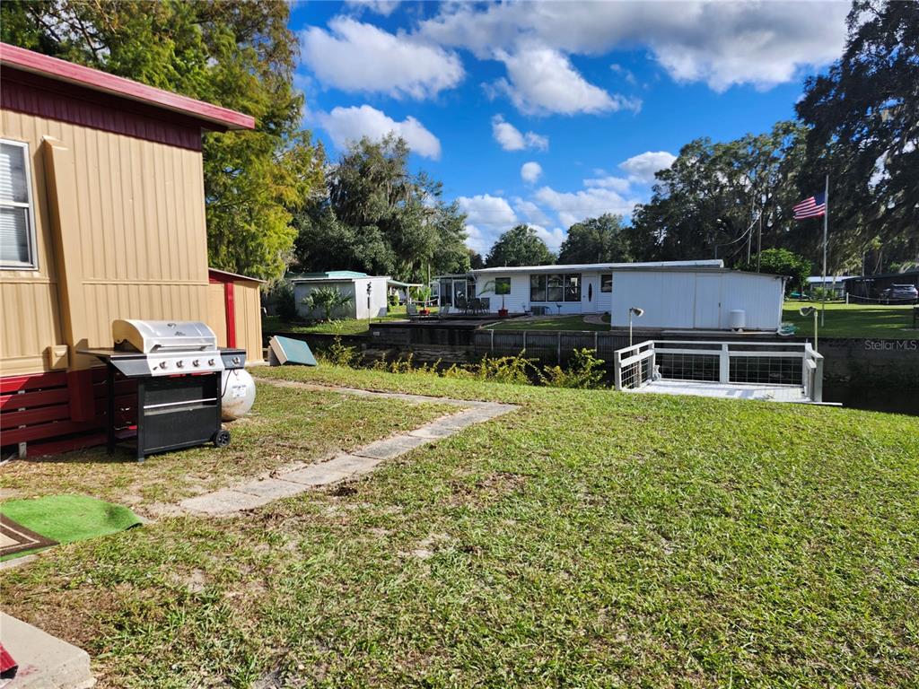 10129 East Bass Circle Inverness, FL 34450 - Photo 25 of 34 a backyard of a house with table and chairs