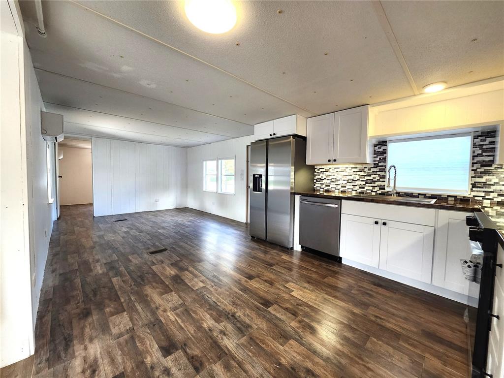 10129 East Bass Circle Inverness, FL 34450 - Photo 7 of 34 a large kitchen with kitchen island a sink stainless steel appliances and cabinets