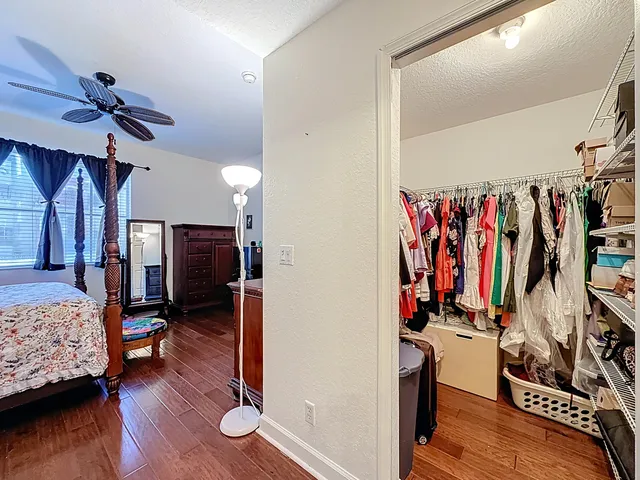 a view of bedroom with furniture and wooden floor