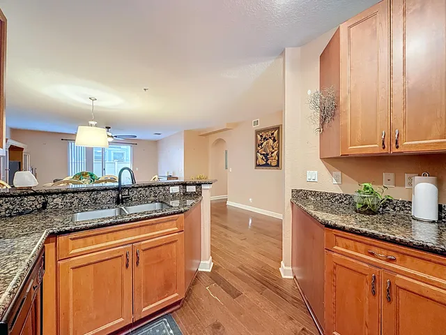 a kitchen with stainless steel appliances granite countertop a refrigerator and a stove