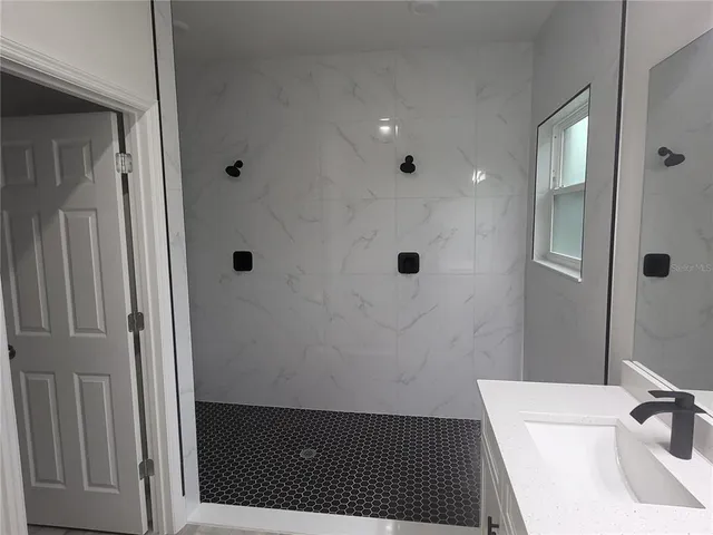 a bathroom with a sink and a shower