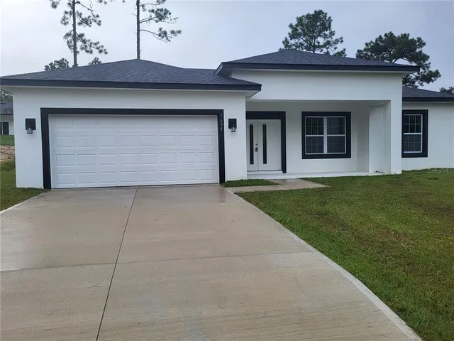 a view of a house with a yard and garage