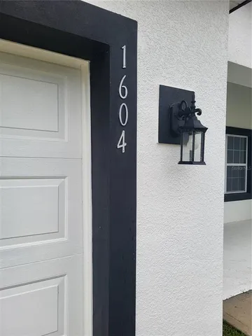 a hallway with table and a potted plant