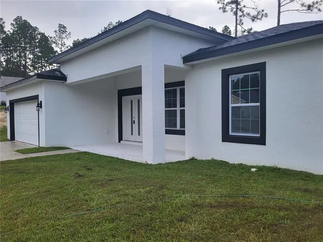 a house that has a big yard with wooden fence