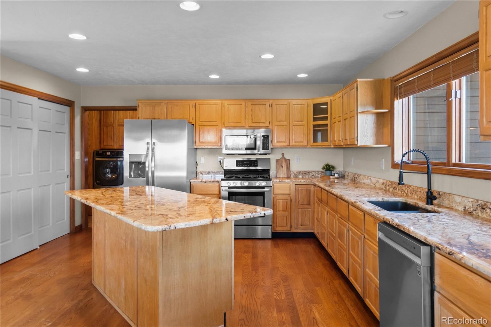 74 Rocky Cliff Road Elizabeth, CO 80107 - Photo 13 of 50 a kitchen with stainless steel appliances granite countertop a sink and a refrigerator