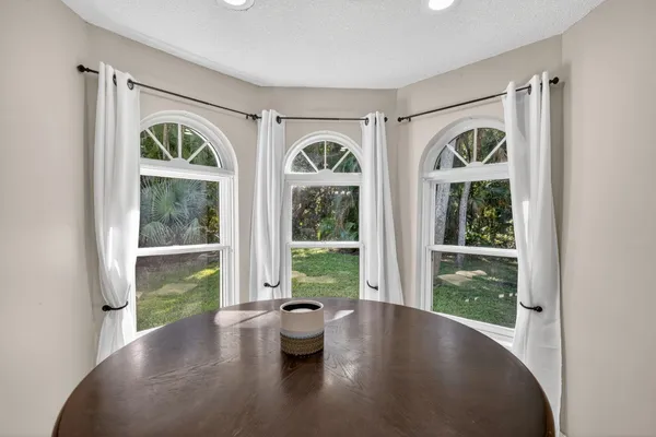 a view of a dining room with furniture window and outside view