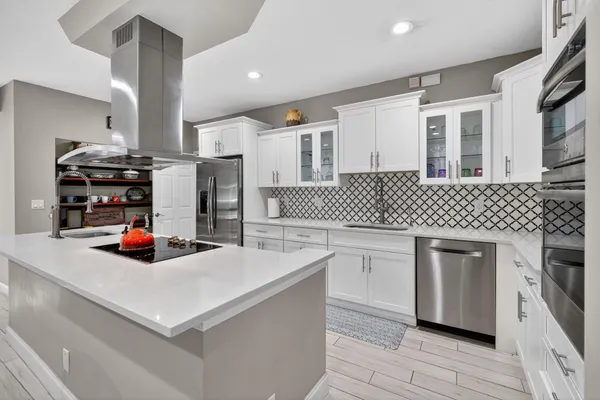 a bedroom with a bed and a large window with wooden floor