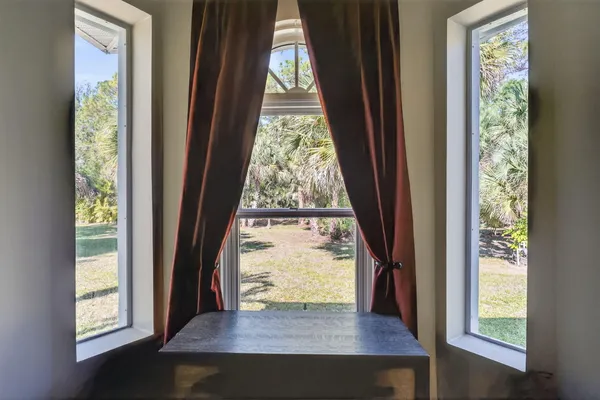 a room with lots of furniture and white walls