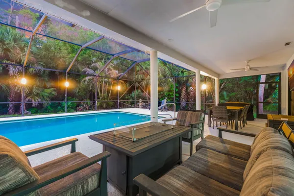 a living room with furniture a wooden floor and a large window