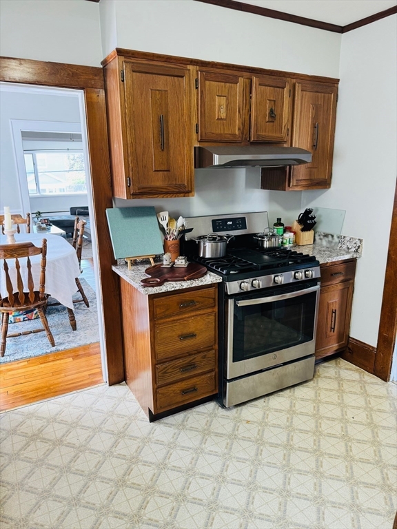 43 Chapman Street, Unit 2 Watertown, MA 02472 - Photo 5 of 12 a kitchen with stainless steel appliances granite countertop a stove a sink and a microwave