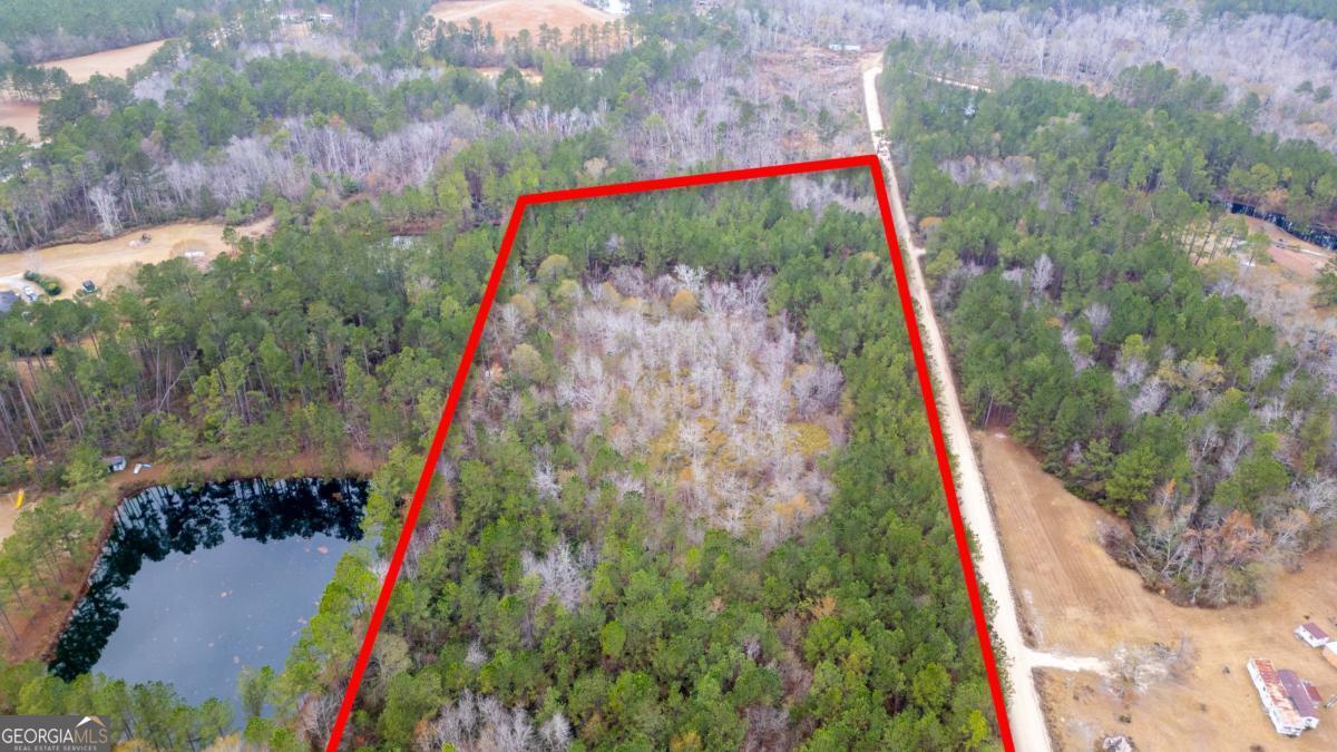 0 Victory Circle Lyons, GA 30436 - Photo 4 of 19 a front view of a house with a yard and fountain