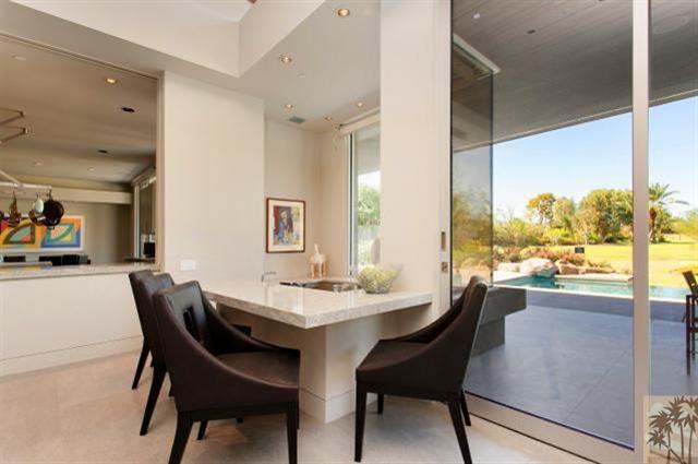 71172 La Paz Road Rancho Mirage, CA 92270 - Photo 12 of 51 a dining room with furniture and a floor to ceiling window