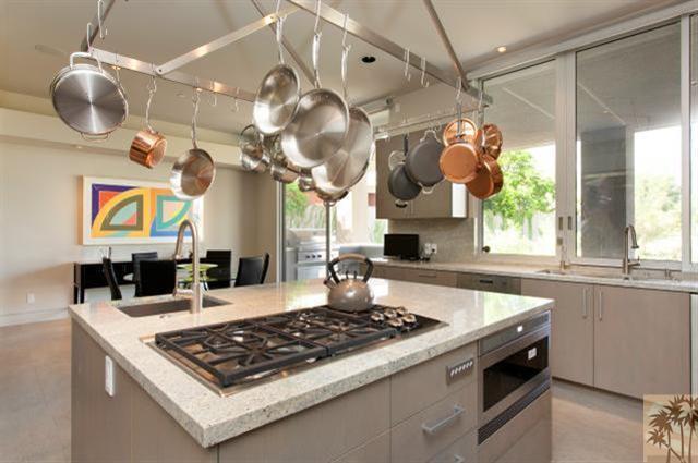 71172 La Paz Road Rancho Mirage, CA 92270 - Photo 13 of 51 a kitchen with a stove a sink a window and dining table