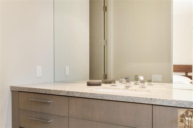 71172 La Paz Road Rancho Mirage, CA 92270 - Photo 27 of 51 a bathroom with a granite countertop sink and a mirror
