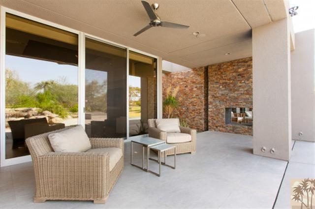 71172 La Paz Road Rancho Mirage, CA 92270 - Photo 35 of 51 a living room with furniture and a floor to ceiling window