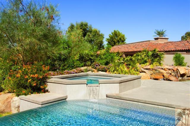 71172 La Paz Road Rancho Mirage, CA 92270 - Photo 37 of 51 a view of a white house with a yard and potted plants