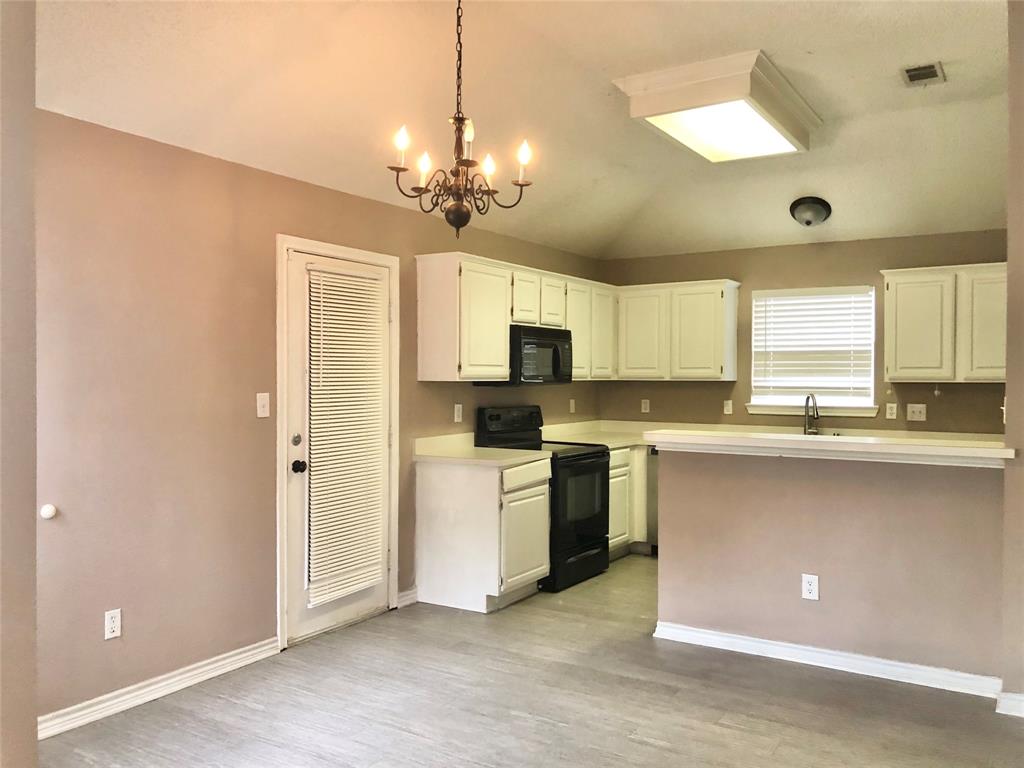 11409 Canoe Road Frisco, TX 75035 - Photo 9 of 19 a open kitchen with a refrigerator a stove top oven a sink and dishwasher