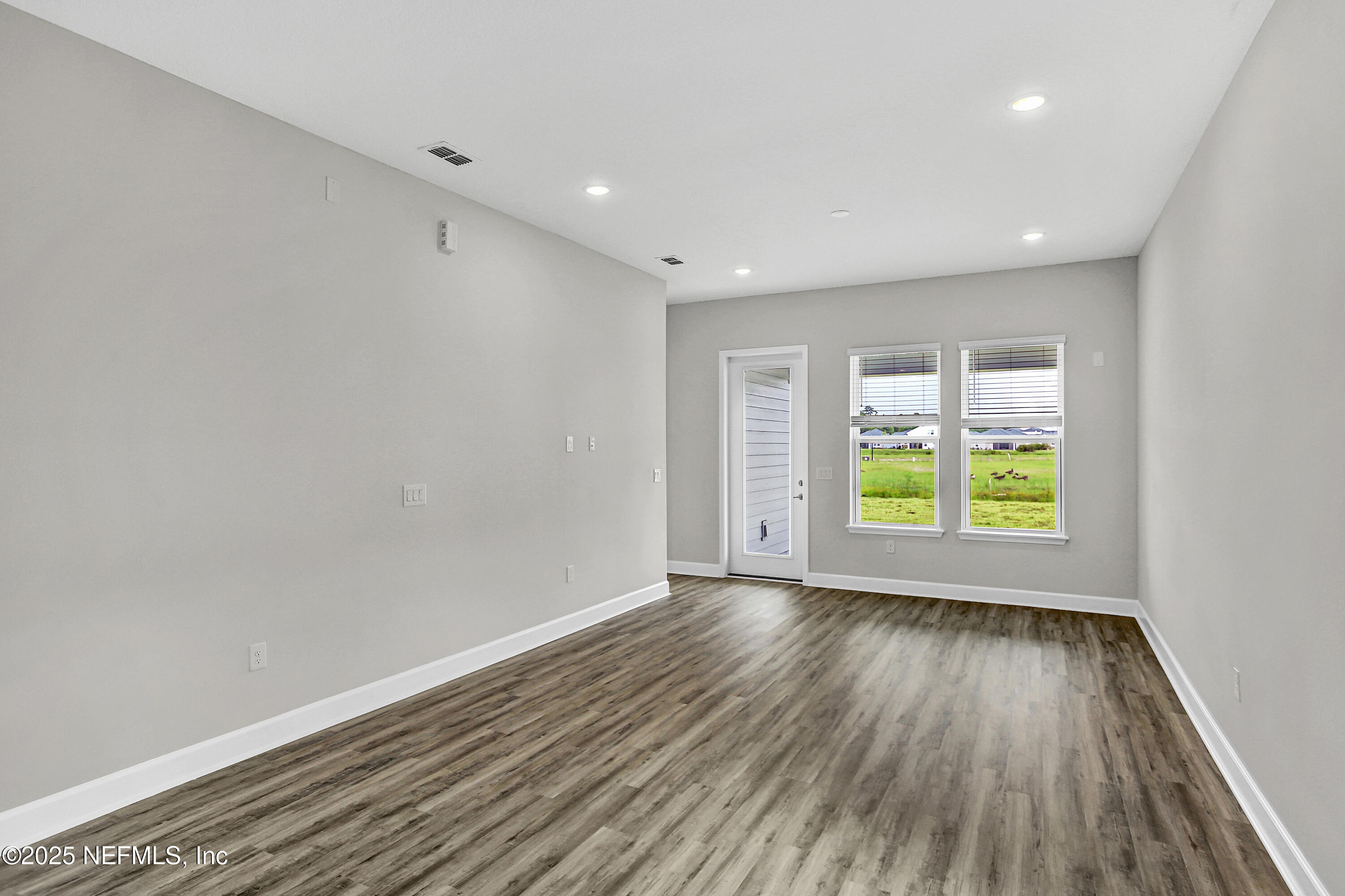 152 Day Dream Drive St. Augustine, FL 32092 - Photo 11 of 34 wooden floor in an empty room with a window