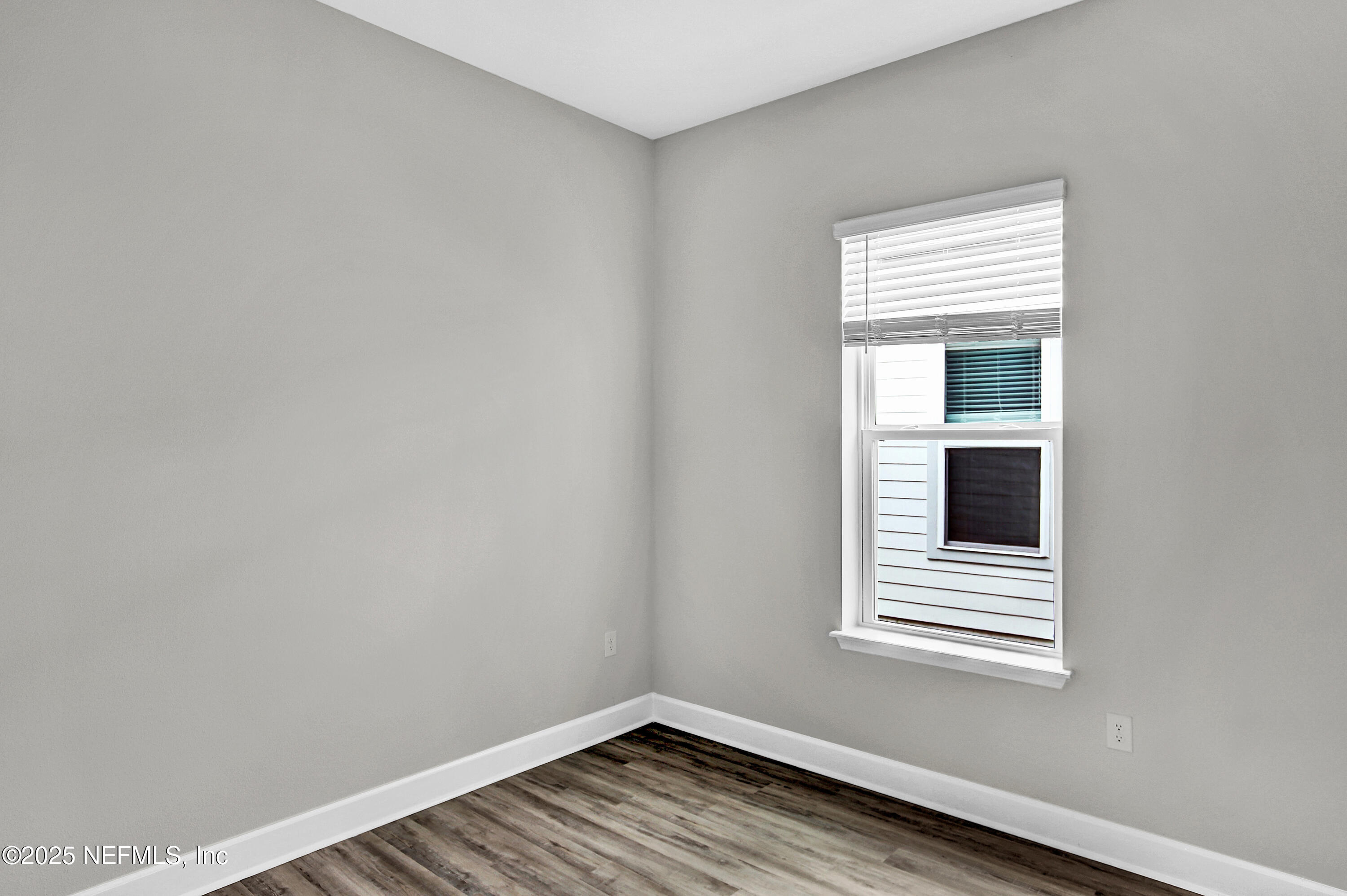 152 Day Dream Drive St. Augustine, FL 32092 - Photo 13 of 34 a view of an empty room with wooden floor and a window