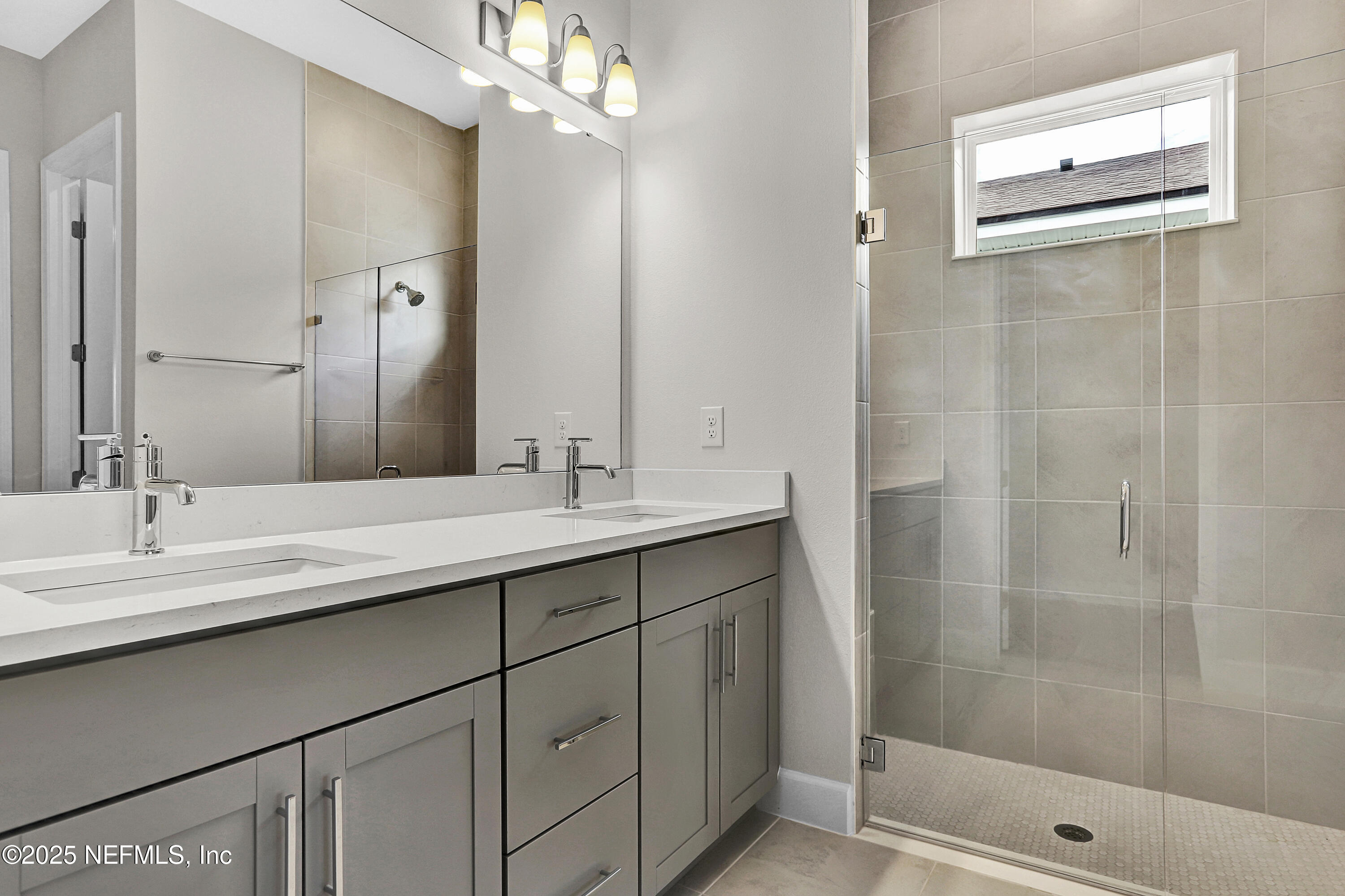 152 Day Dream Drive St. Augustine, FL 32092 - Photo 16 of 34 a bathroom with a double vanity sink a shower and a mirror