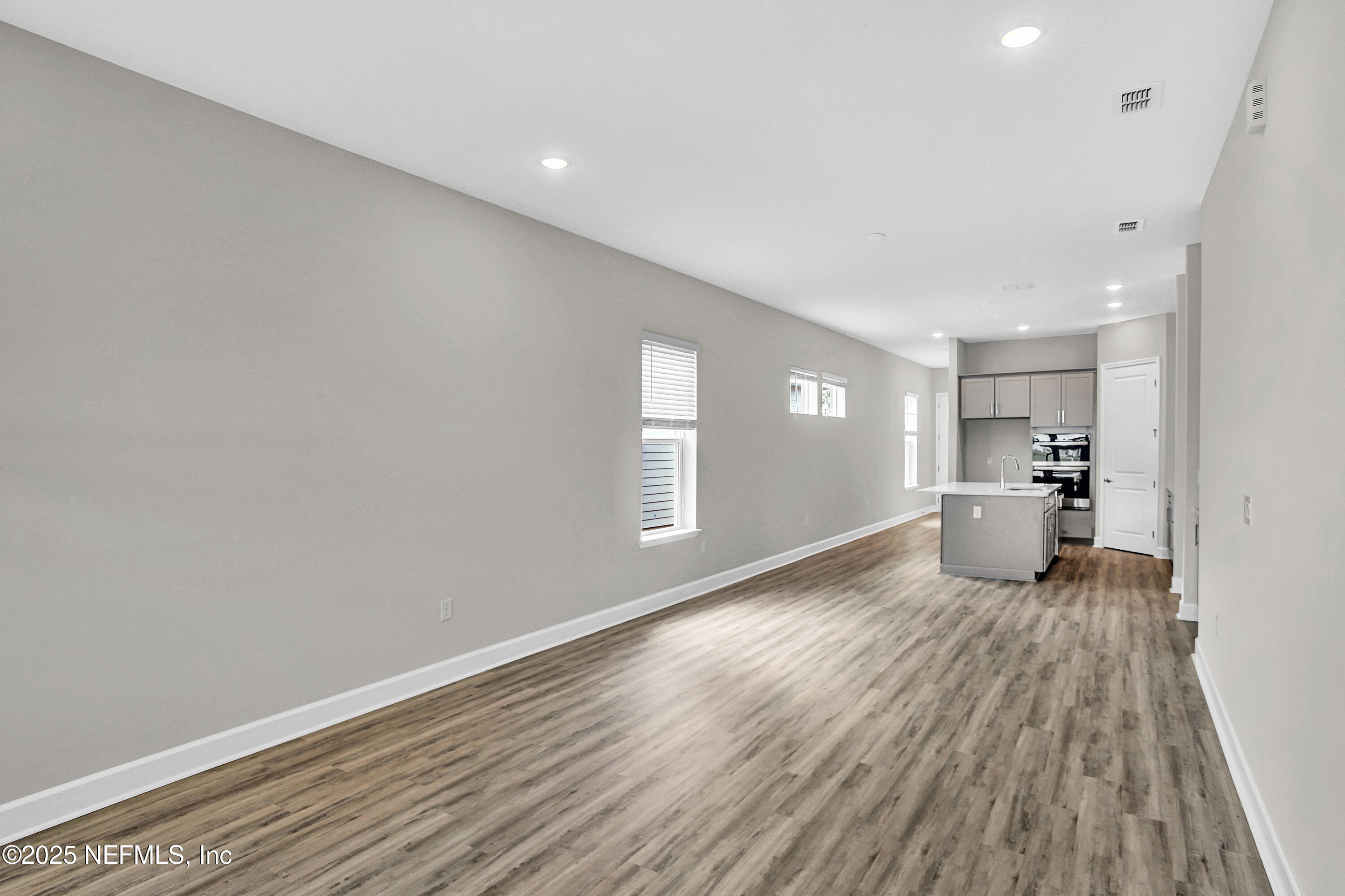 152 Day Dream Drive St. Augustine, FL 32092 - Photo 19 of 34 a big room with wooden floor and windows