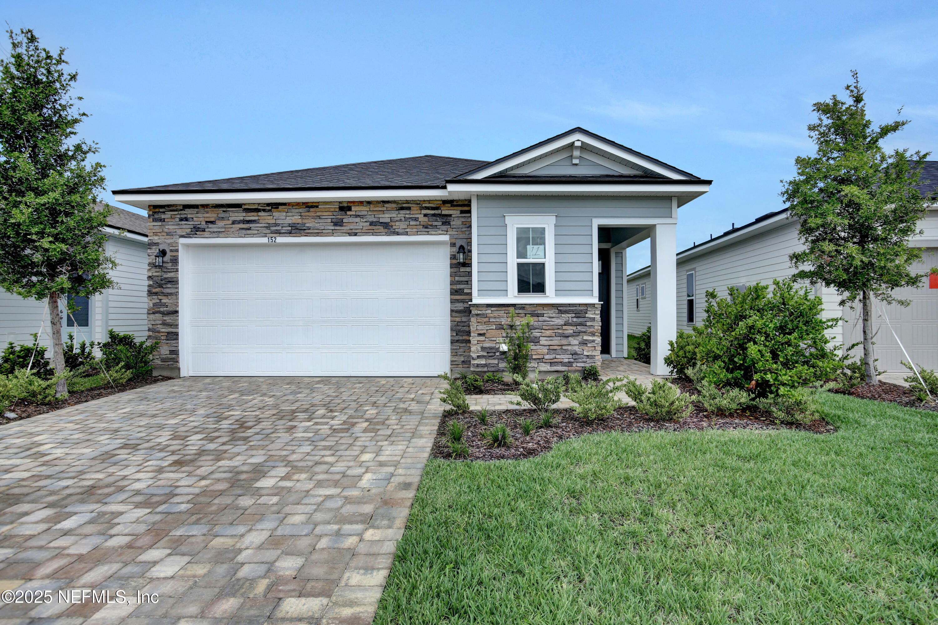 152 Day Dream Drive St. Augustine, FL 32092 - Photo 2 of 34 a front view of a house with a garden