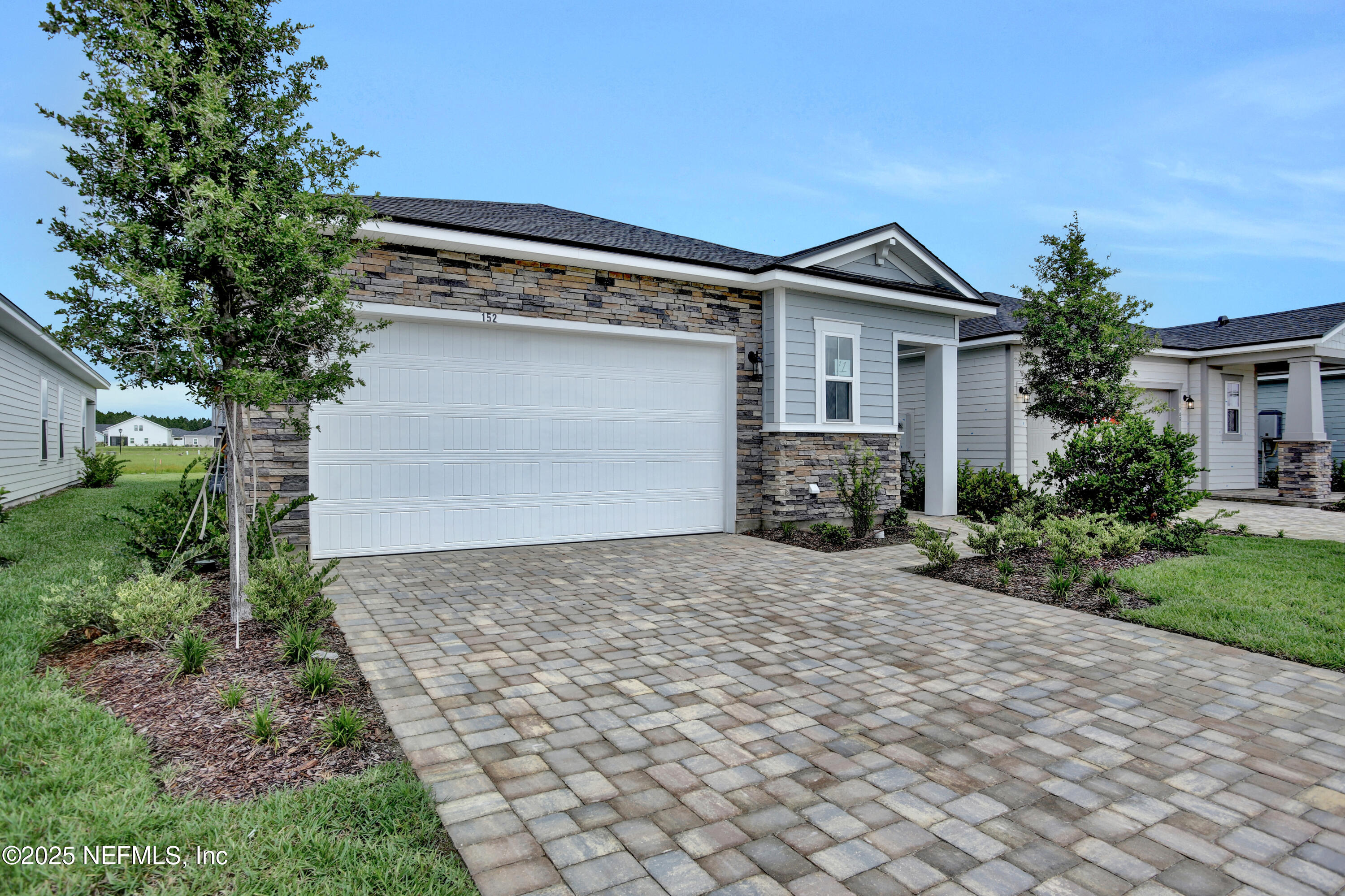 152 Day Dream Drive St. Augustine, FL 32092 - Photo 3 of 34 a front view of a house with a yard and garage