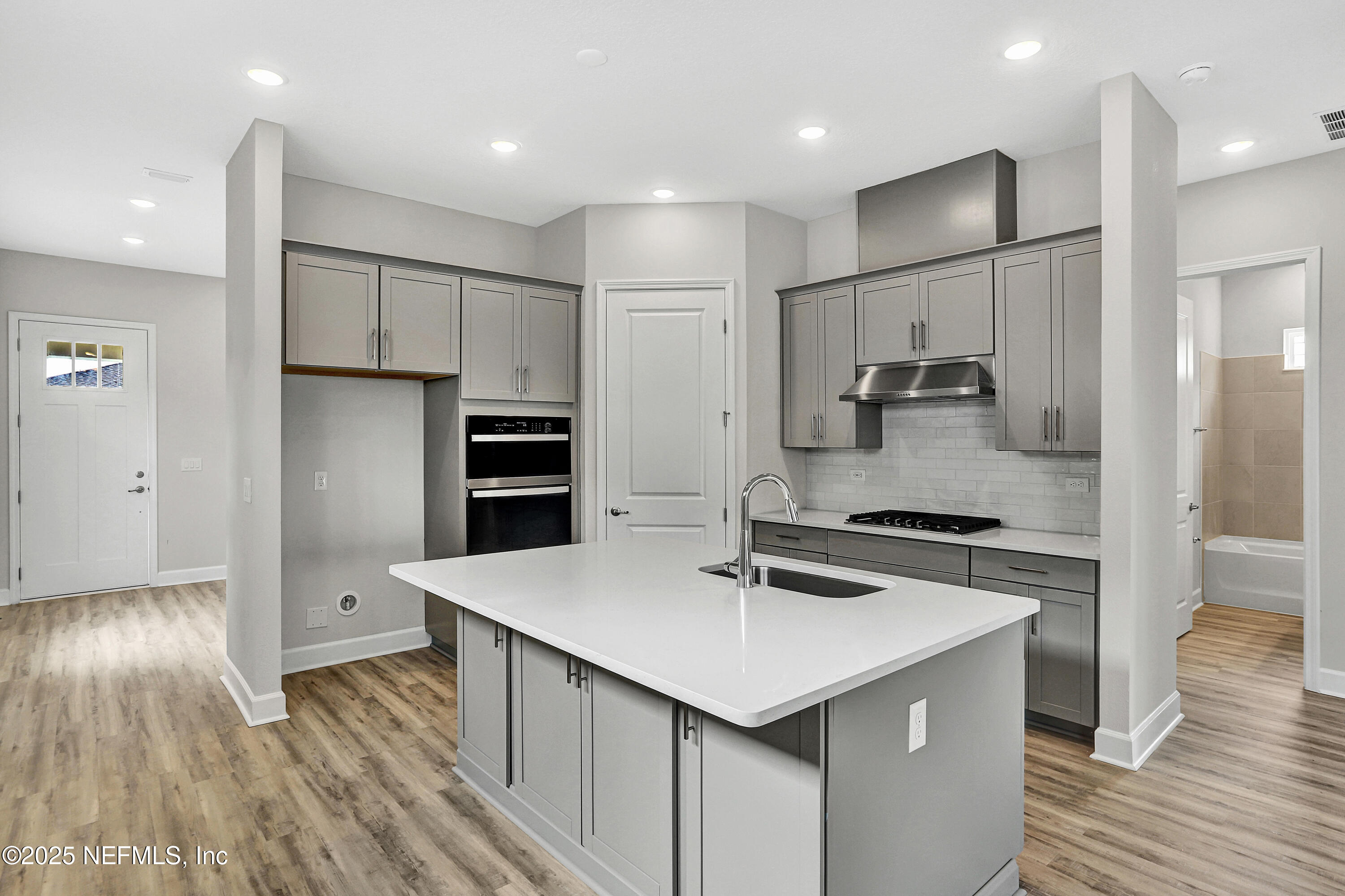 152 Day Dream Drive St. Augustine, FL 32092 - Photo 8 of 34 a kitchen with a sink stainless steel appliances and wooden floor