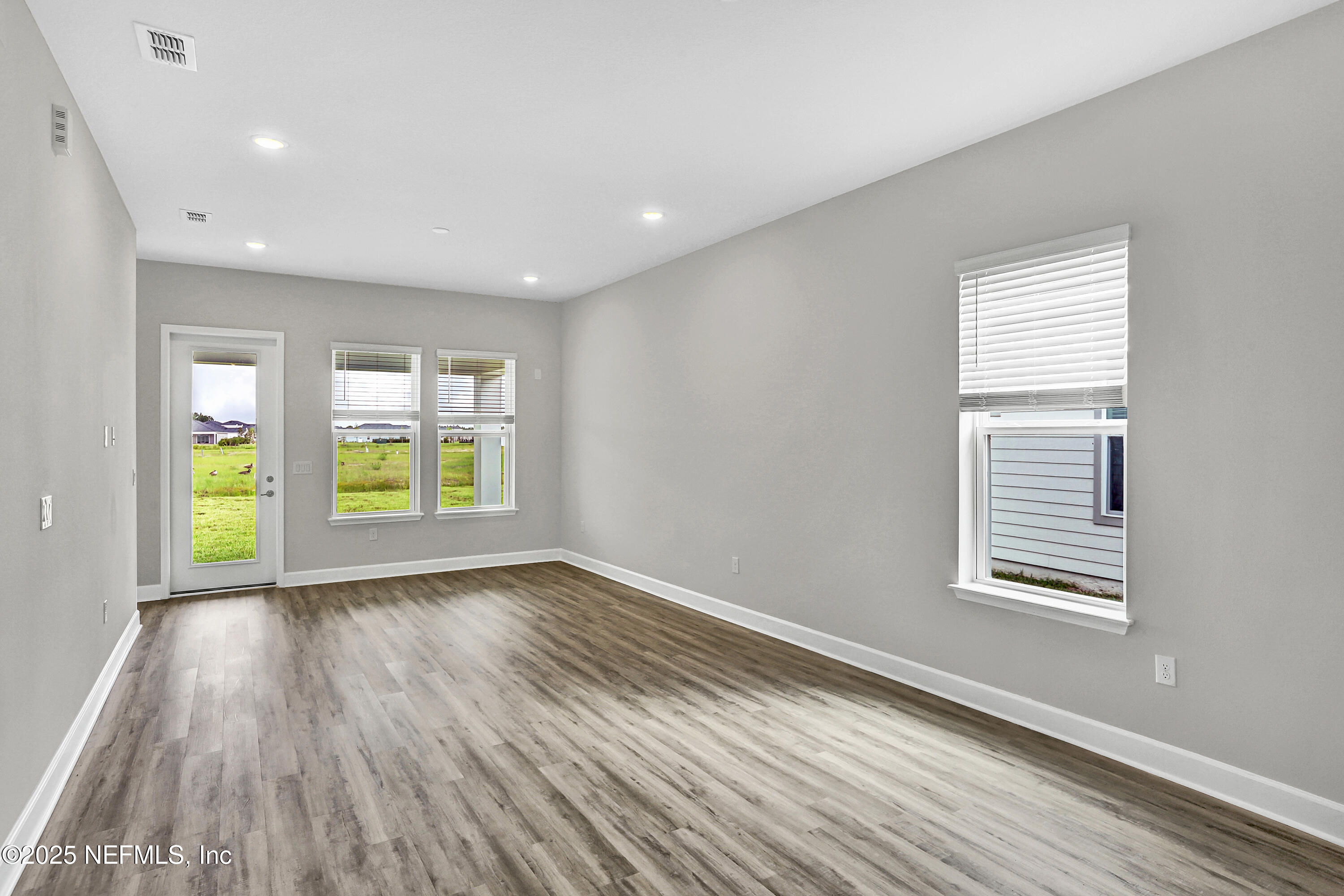 152 Day Dream Drive St. Augustine, FL 32092 - Photo 10 of 34 a view of an empty room with wooden floor and a window