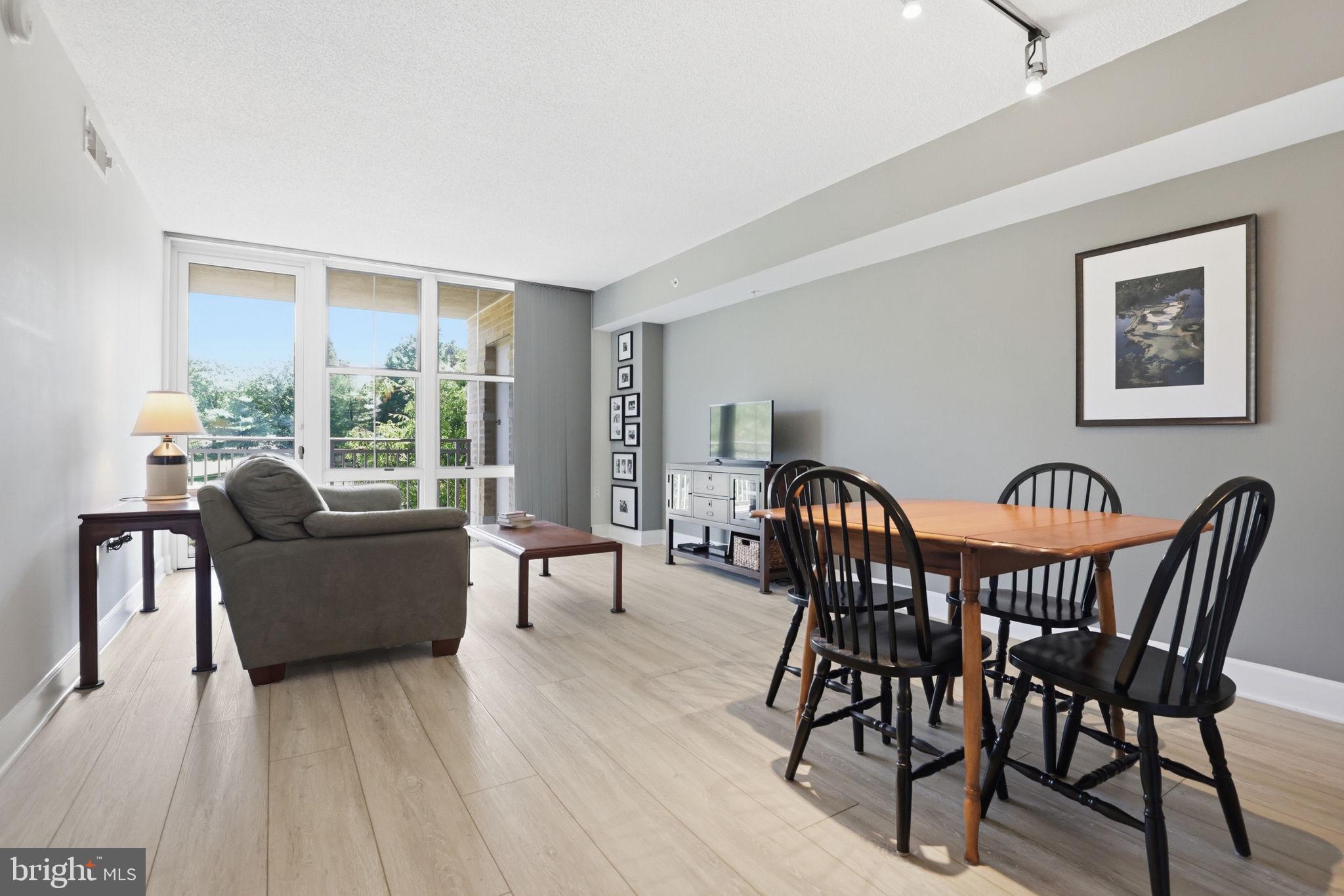 11800 Sunset Hills Road, Unit 218 Reston, VA 20190 - Photo 13 of 38 a view of a dining room with furniture and wooden floor