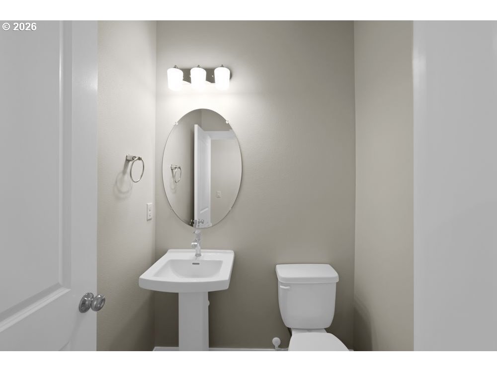 448 Southwest 32nd Street Battle Ground, WA 98604 - Photo 12 of 15 a bathroom with a toilet sink and mirror