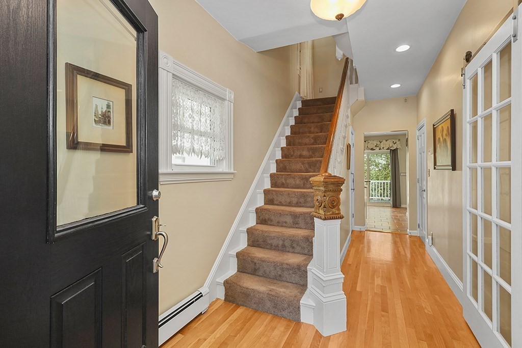 339 Winthrop Street Winthrop, MA 02152 - Photo 3 of 42 a view of staircase with lots of frames on wall and windows
