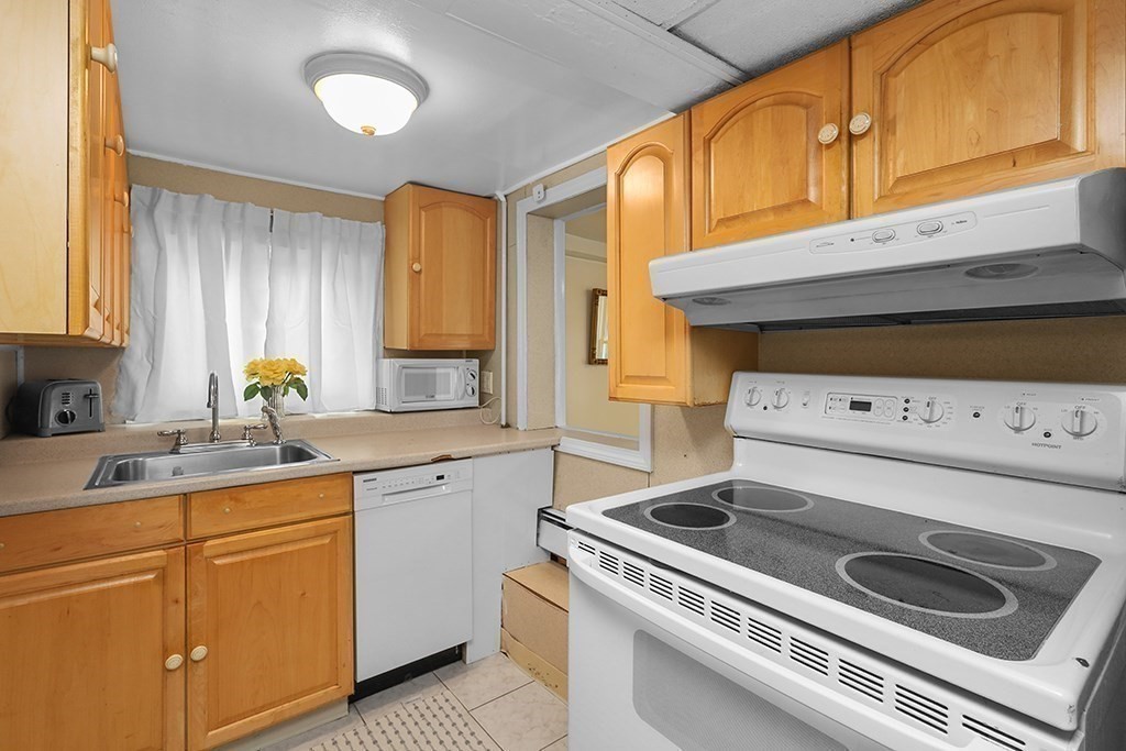 339 Winthrop Street Winthrop, MA 02152 - Photo 32 of 42 a kitchen with a stove and white cabinets