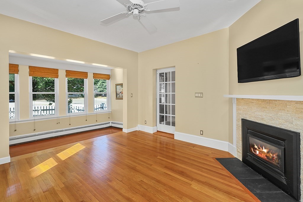 339 Winthrop Street Winthrop, MA 02152 - Photo 4 of 42 a view of an empty room with wooden floor fireplace and a window